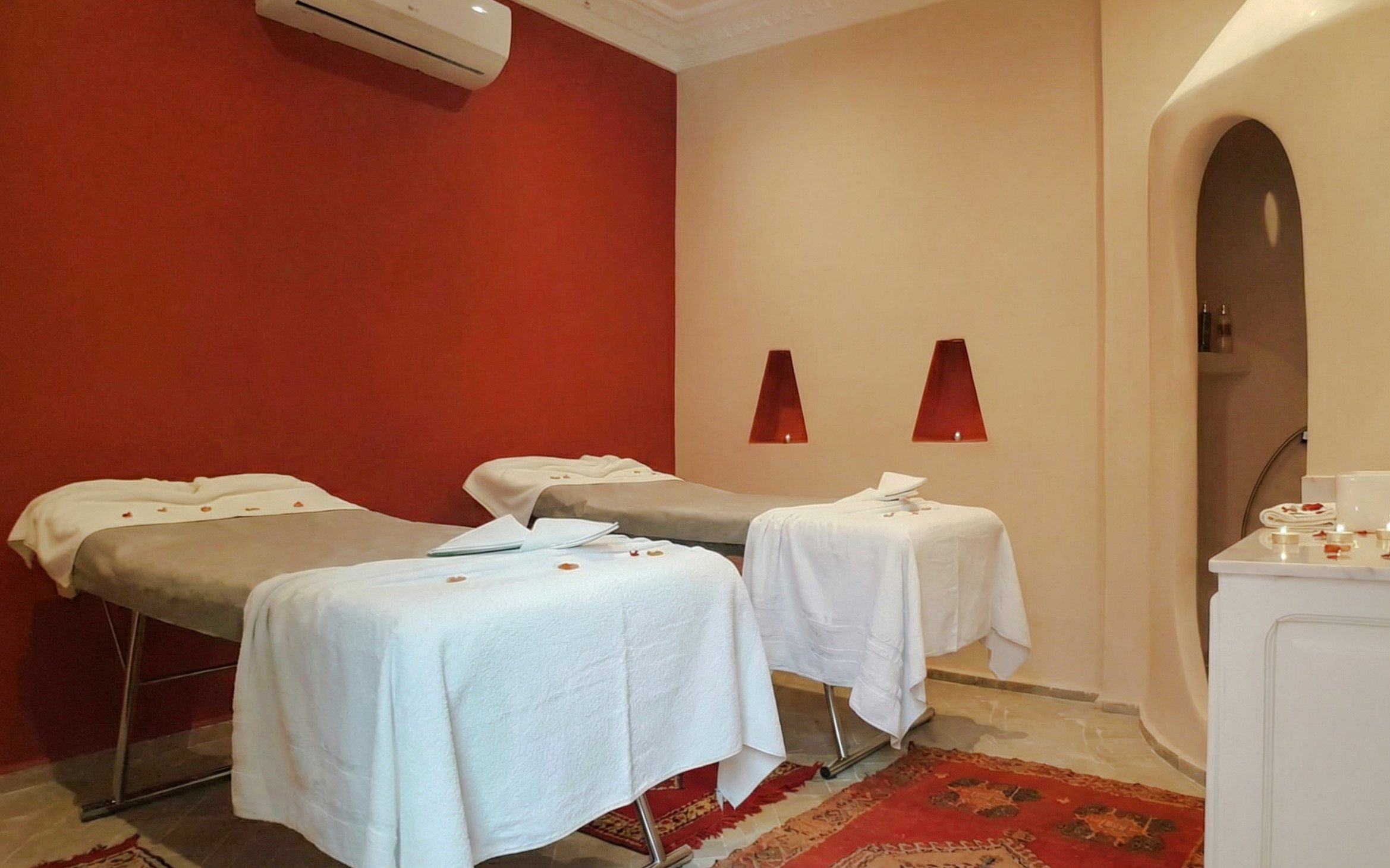 Spa therapy room with massage tables and candles at Moroccan Hammam, Marrakech.