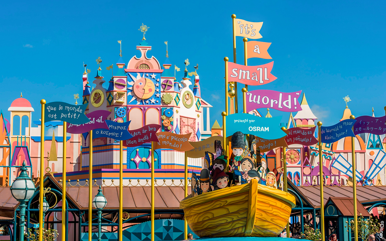 Small World ride boats at Disneyland Paris Park with colorful international dolls.