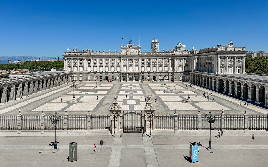 Royal Palace of Madrid courtyard with tourists, Spain.