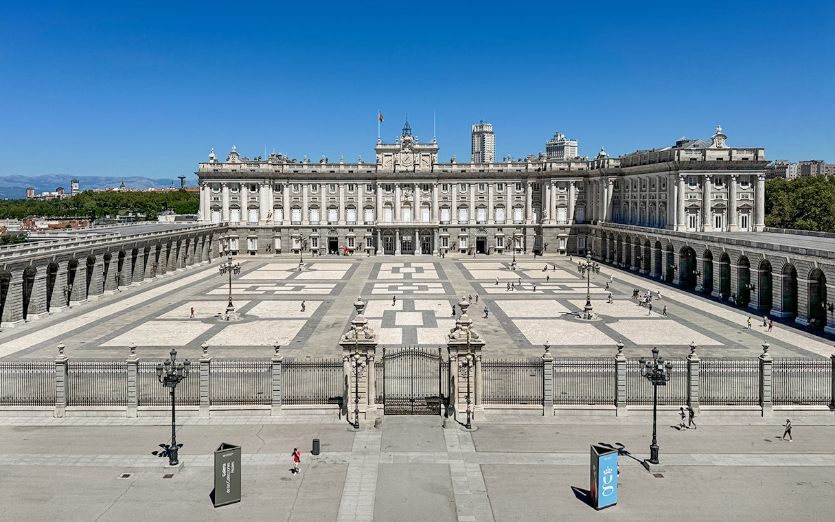 Royal Palace of Madrid courtyard with tourists, Spain.
