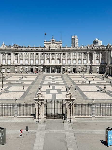 Royal Palace of Madrid courtyard with tourists, Spain.
