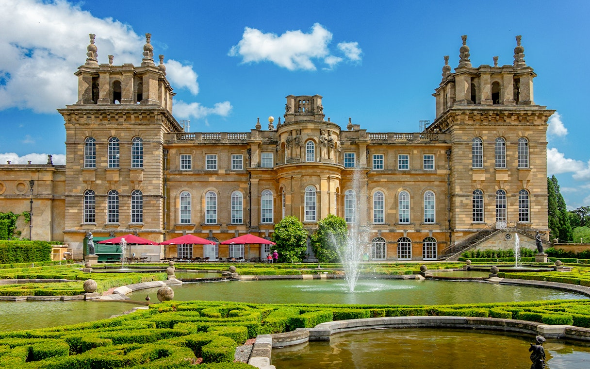 Blenheim Palace gardens with fountains and historic architecture, London tour.