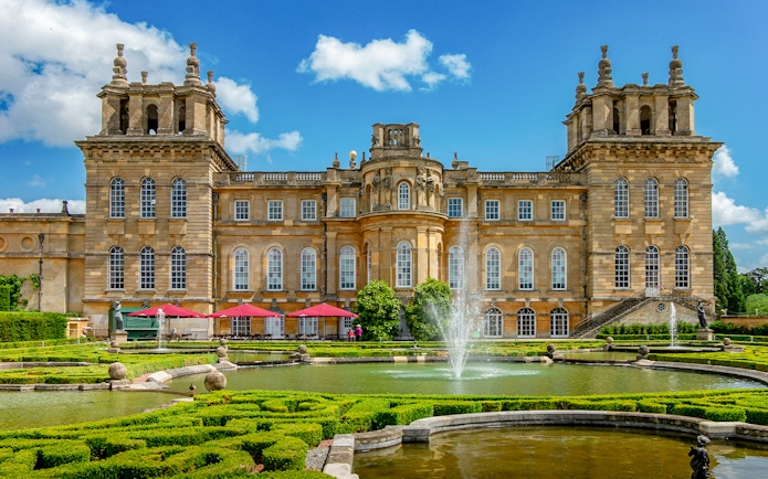 Blenheim Palace gardens with fountains and historic architecture, London tour.
