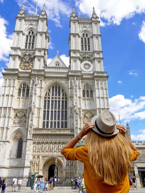 Westminster Abbey facade with visitor during 3-hour walking tour, London.