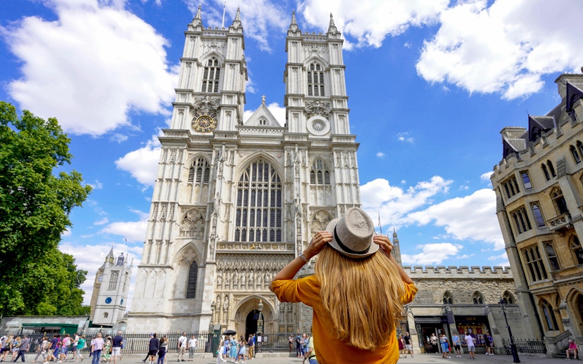 Westminster Abbey facade with visitor during 3-hour walking tour, London.