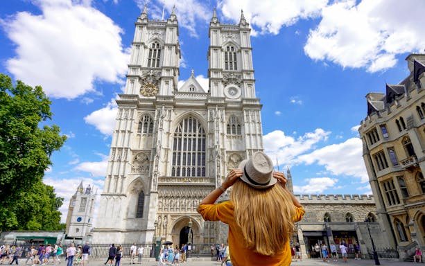 Westminster Abbey facade with visitor during 3-hour walking tour, London.