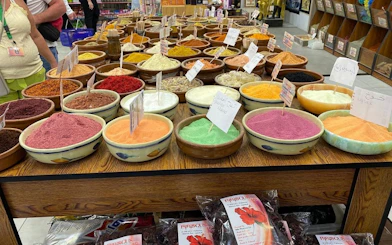 Bowls of colorful spices on display in a Hurghada market during a private shopping tour.