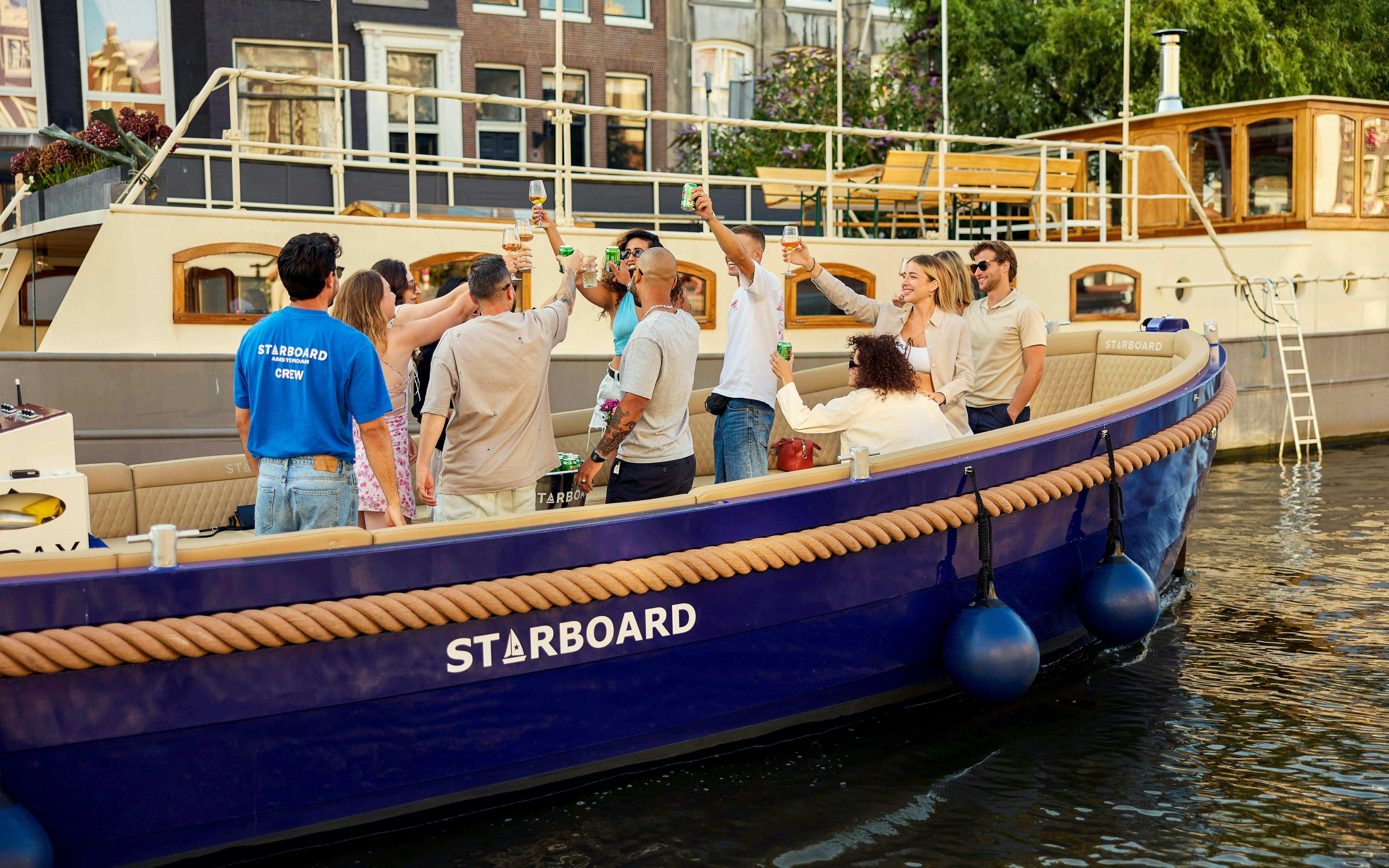 Guests enjoying drinks on a canal cruise in Amsterdam.