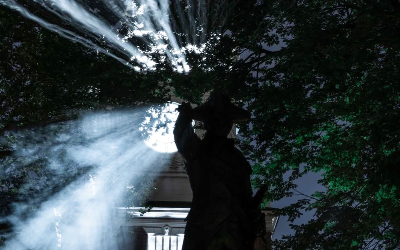 Silhouette of a statue with eerie lighting during Philadelphia Haunted Halloween Tour.