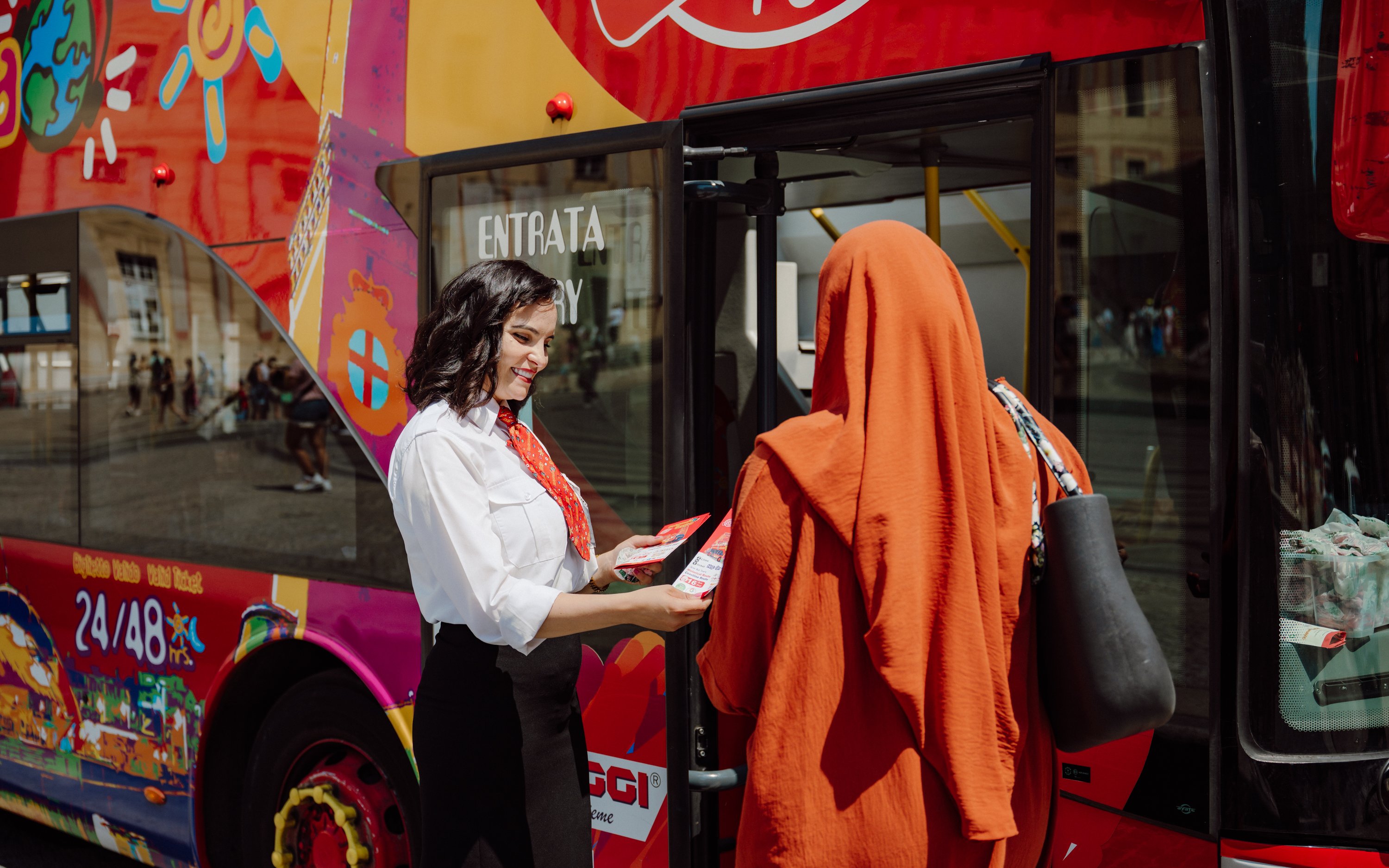 Tourist with guide boarding Genoa city sightseeing bus.