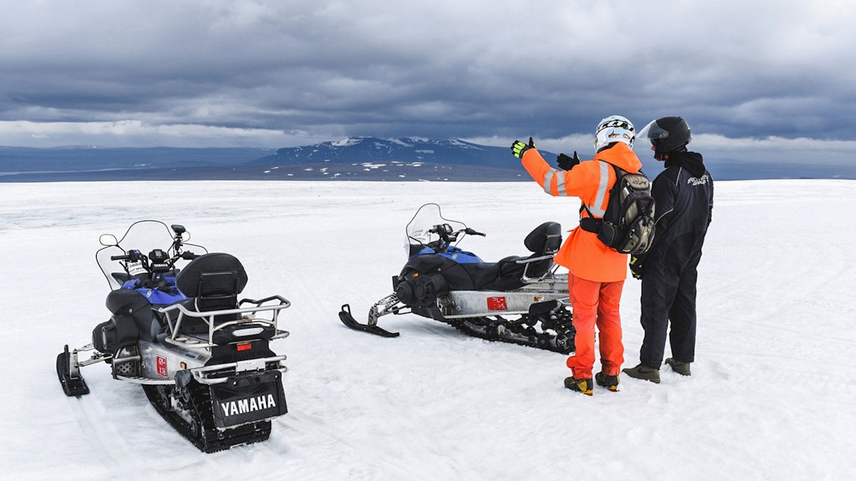 Snowmobilers on glacier during Secret Lagoon hot spring tour in Iceland.