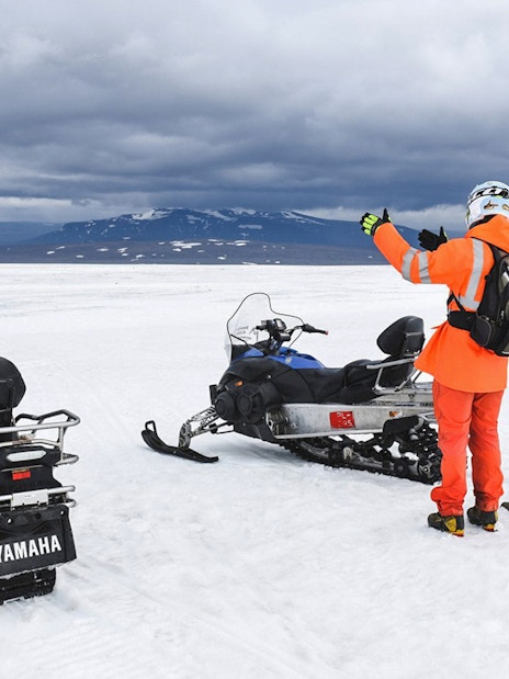 Snowmobilers on glacier during Secret Lagoon hot spring tour in Iceland.