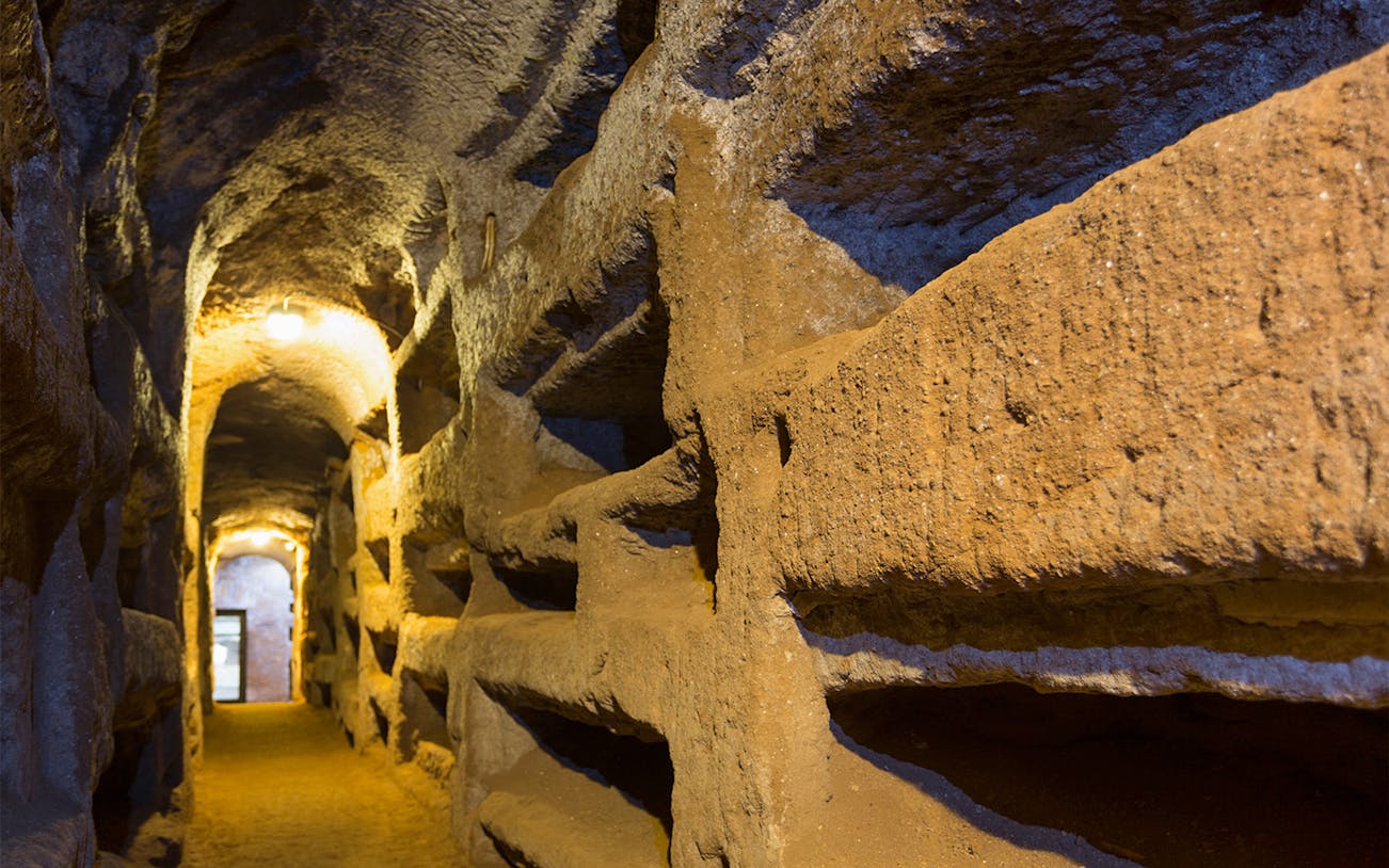 Catacomb passageway with niches on the Appian Way, Italy.