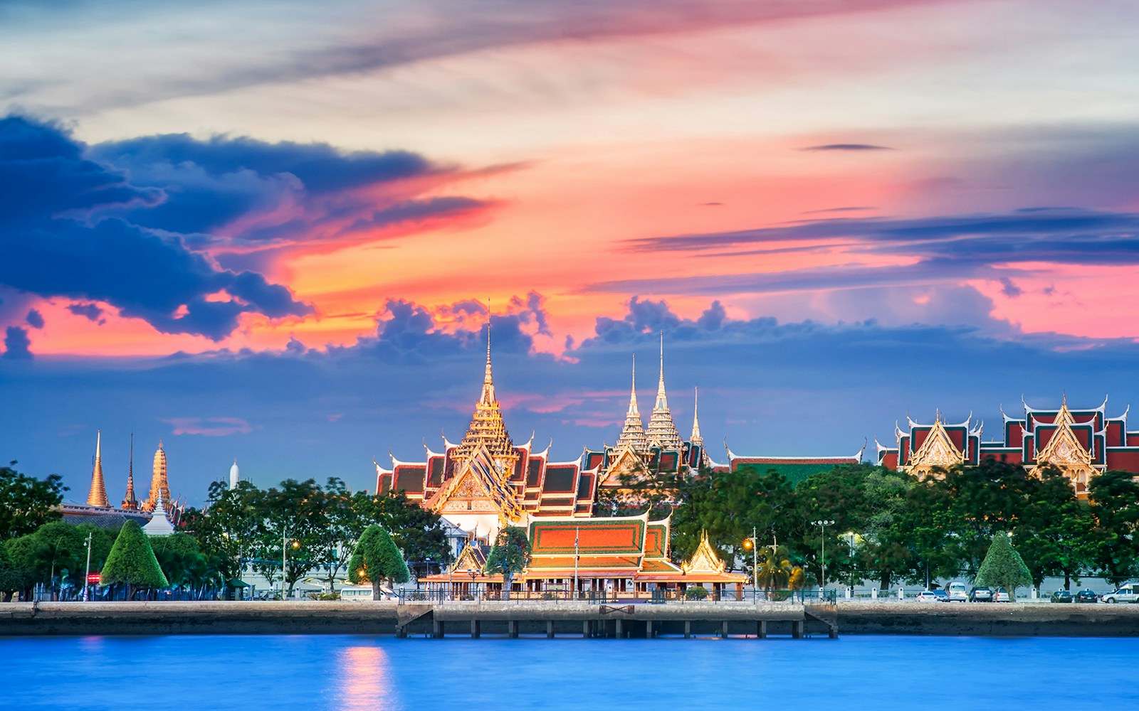 Grand Palace with vibrant sunset sky, Bangkok, Thailand.