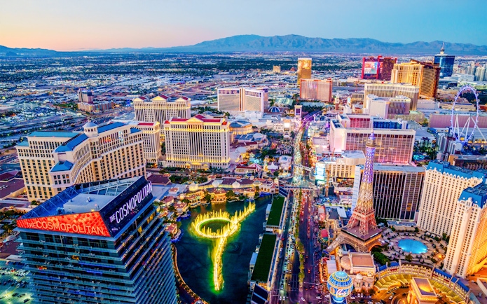Aerial view of Las Vegas Strip at night with neon lights and fountains, Nevada.