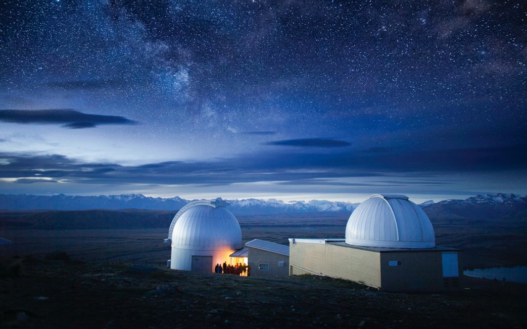 Mt. John Observatory domes under starry sky, Lake Tekapo, New Zealand.