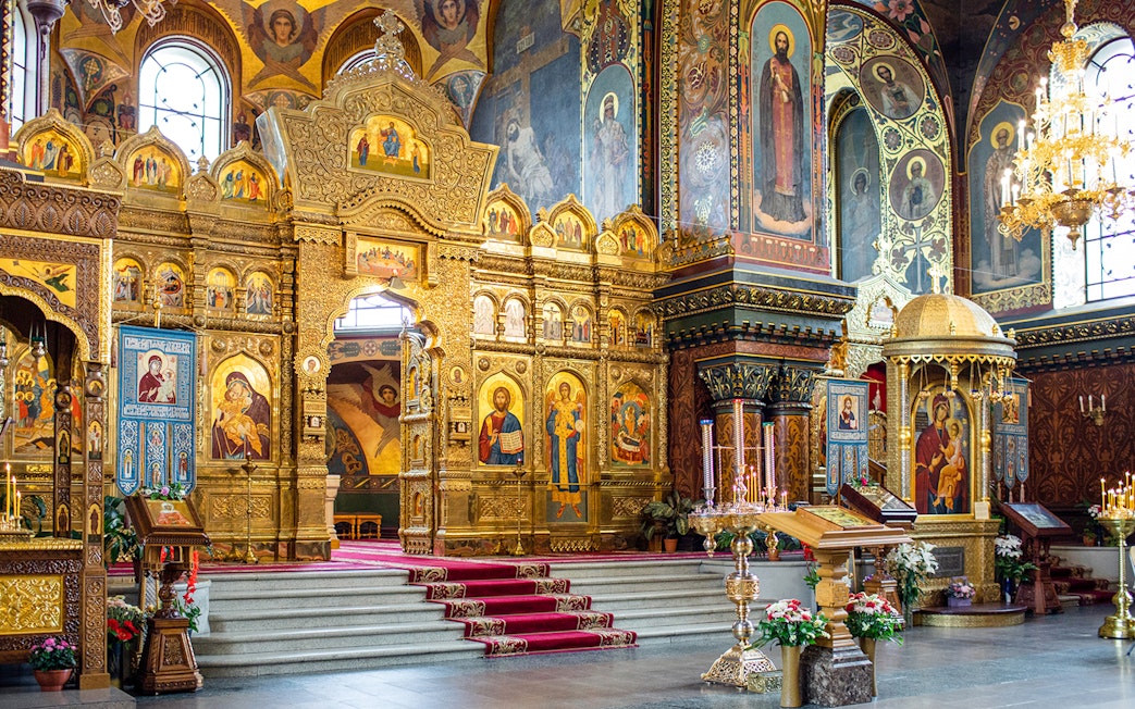 Interior of St Vitus Cathedral featuring ornate gold altar and religious iconography.