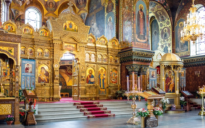 Interior of St Vitus Cathedral featuring ornate gold altar and religious iconography.