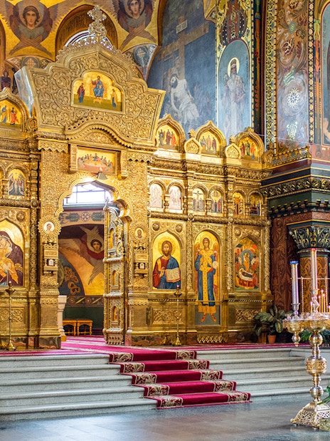 Interior of St Vitus Cathedral featuring ornate gold altar and religious iconography.