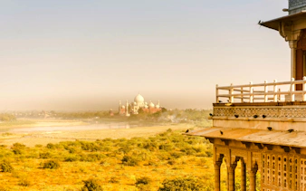 Agra Fort view with Taj Mahal in the distance, part of a private guided heritage tour in Agra.