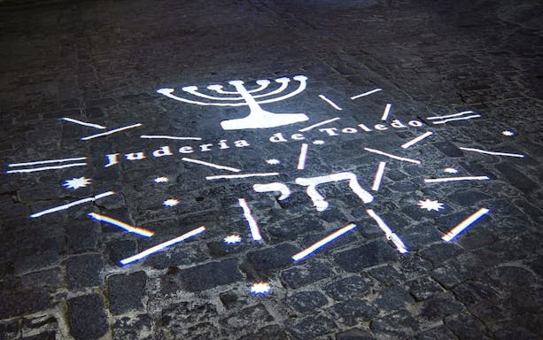 Projected menorah and "Judería de Toledo" on cobblestone, Una Mágica noche Toledana.