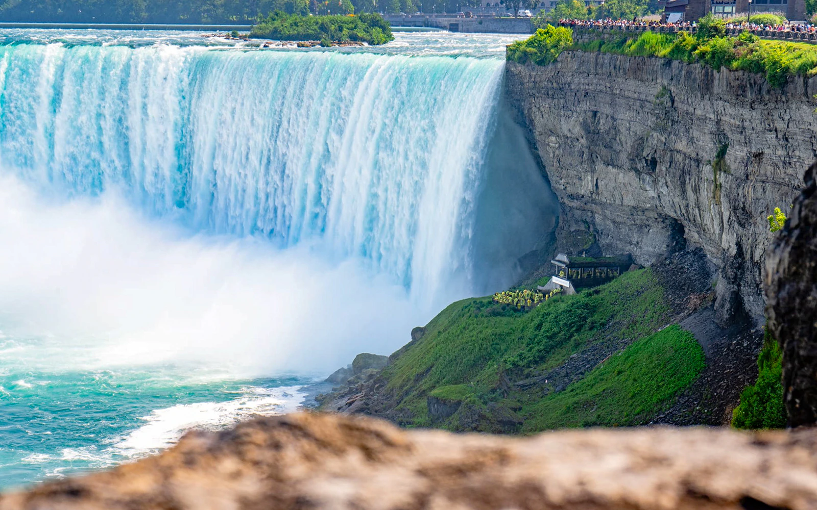 People at Journey Behind the Falls, Niagara Falls, viewing cascading water.