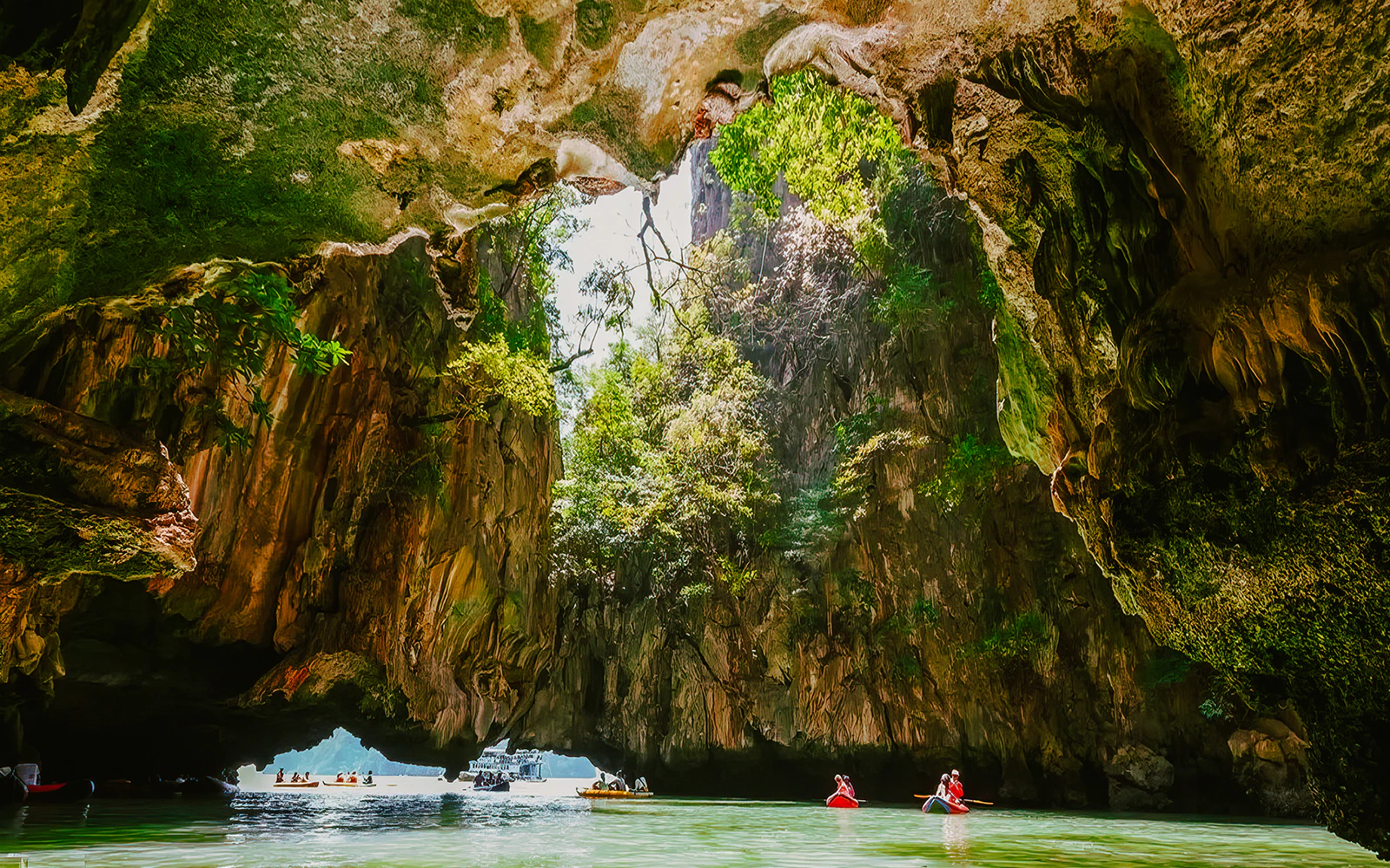 Kayakers exploring cave formations on James Bond Island tour.