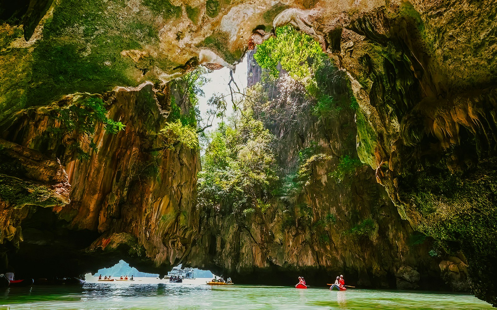 Kayakers exploring cave formations on James Bond Island tour.