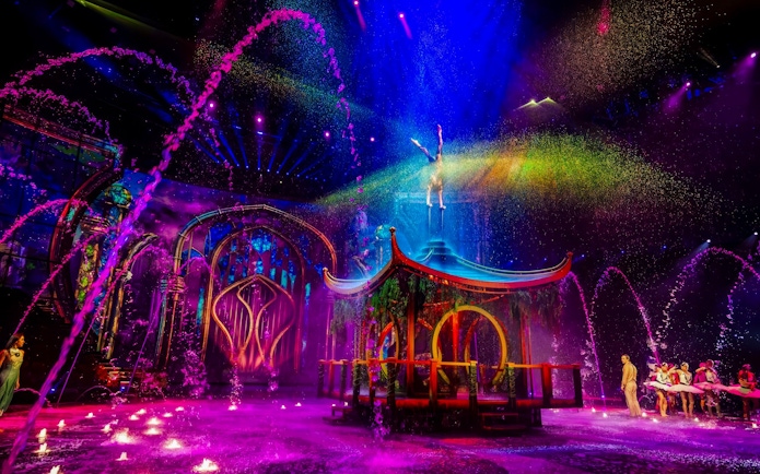 Water jets and colorful lights at House of Dancing Water Show performance.