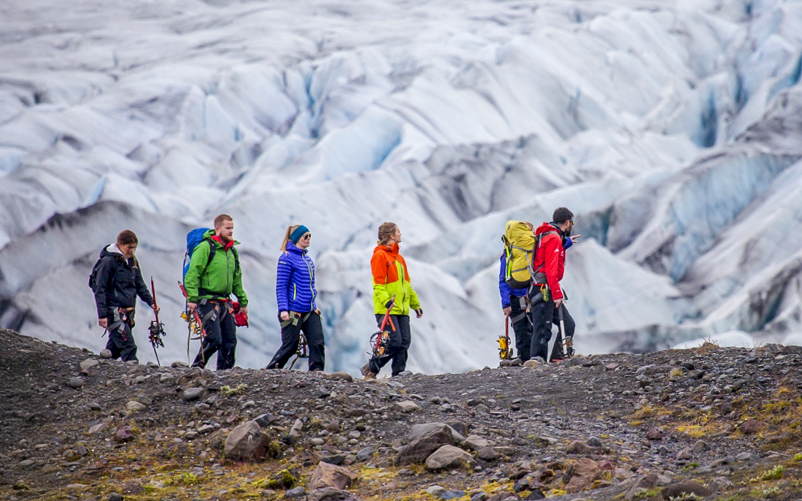 Group hiking on Skaftafell glacier with ice climbing gear.