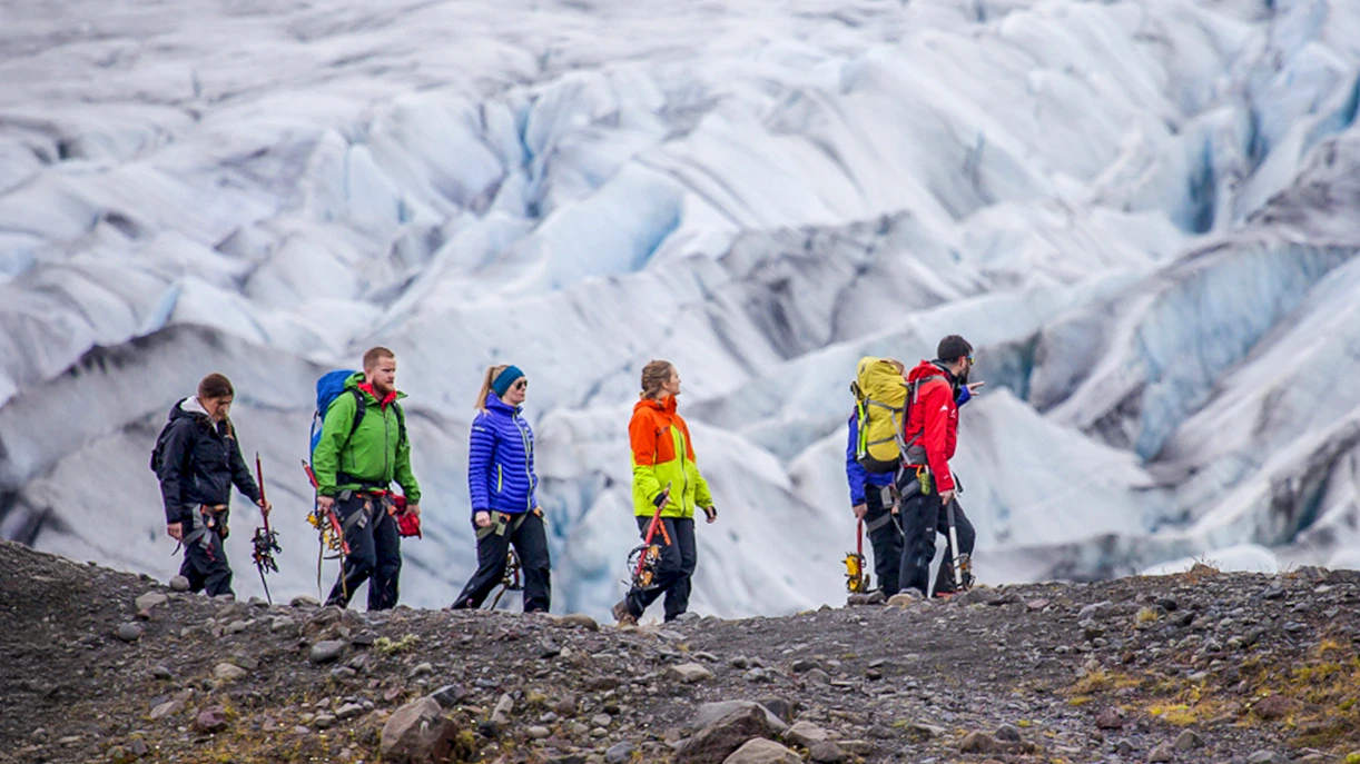 Group hiking on Skaftafell glacier with ice climbing gear.