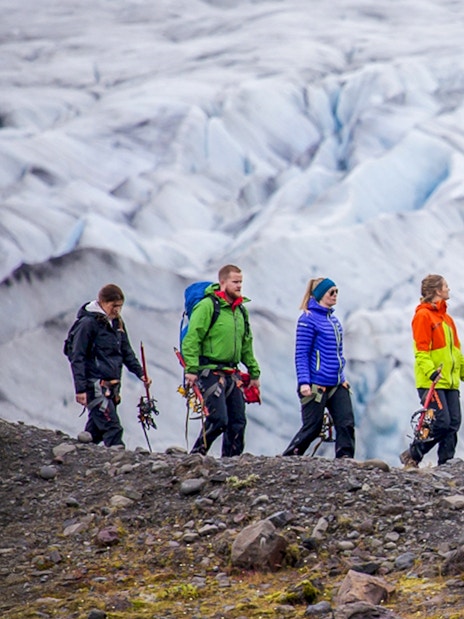 Group hiking on Skaftafell glacier with ice climbing gear.