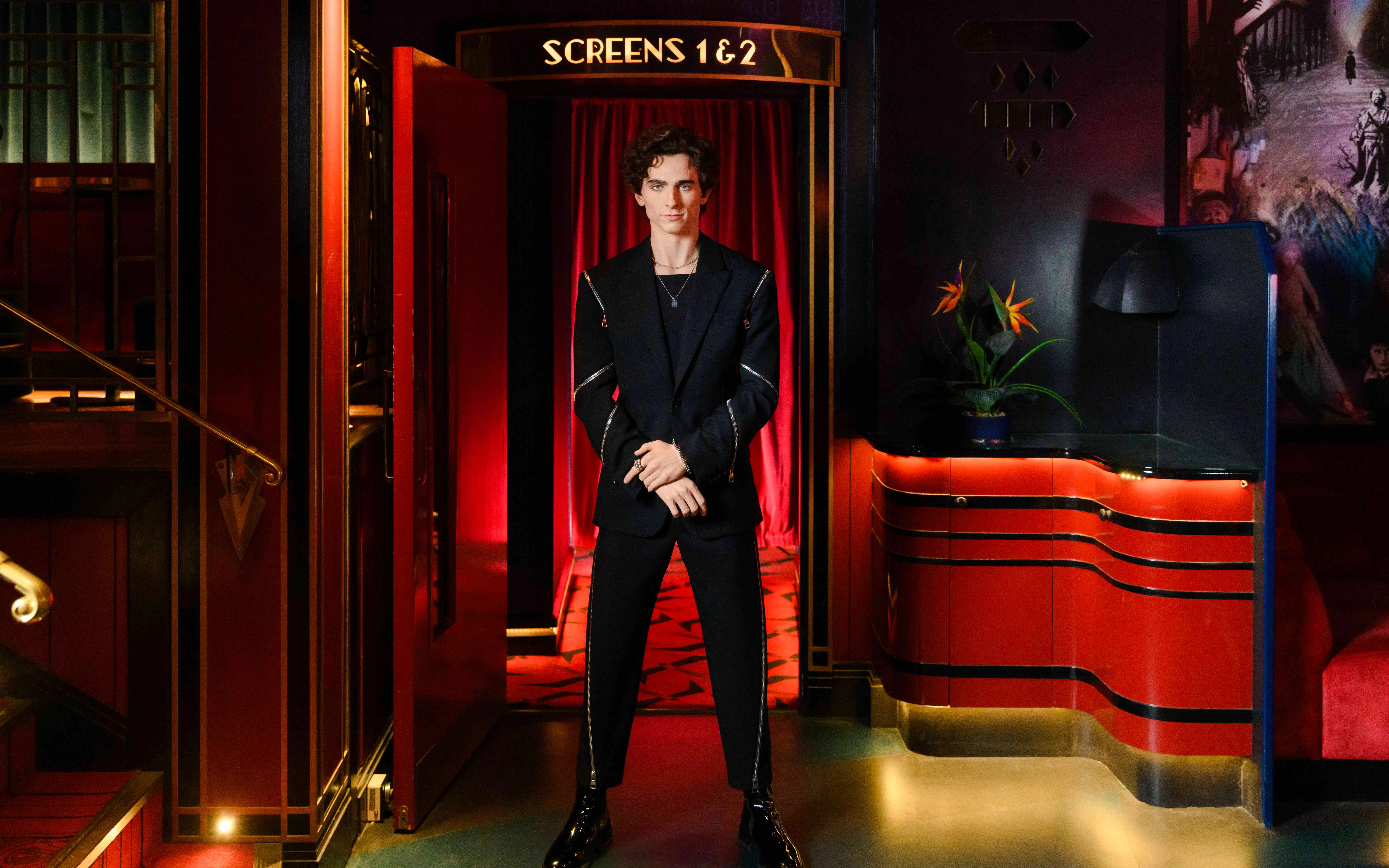 Wax figure of Timothée Chalamet at Madame Tussauds London in a theater setting.