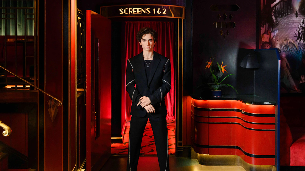 Wax figure of Timothée Chalamet at Madame Tussauds London in a theater setting.