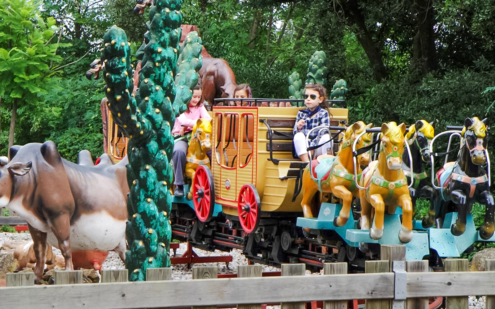 Children riding a pony-themed train at Tibidabo Amusement Park.