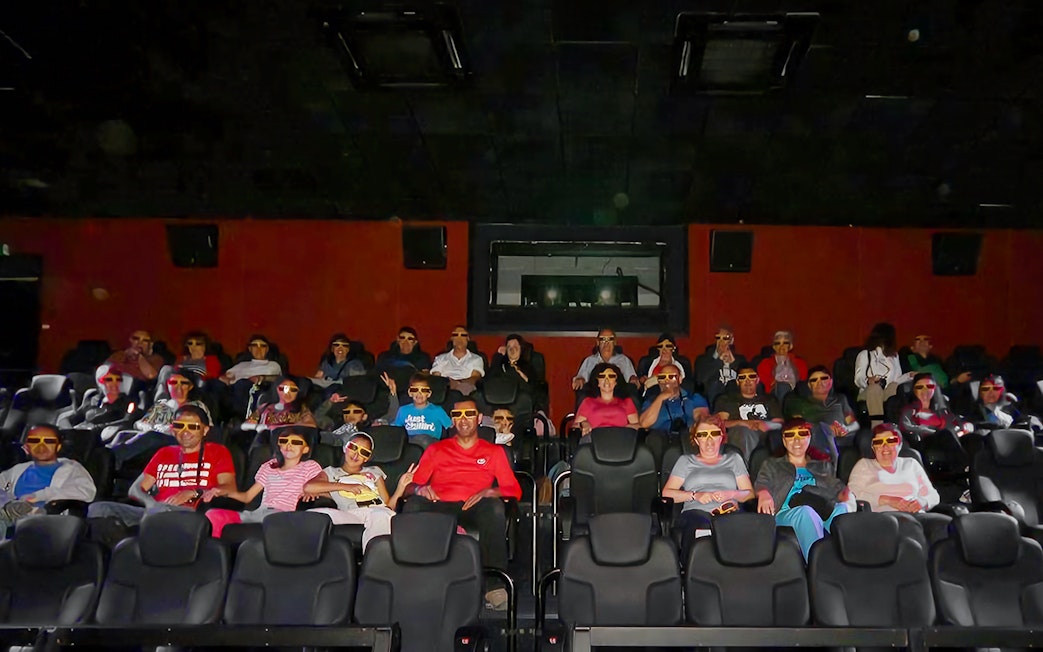 Visitors wearing 3D glasses seated in the viewing hall at Malta 5D Audio-Visual Show.
