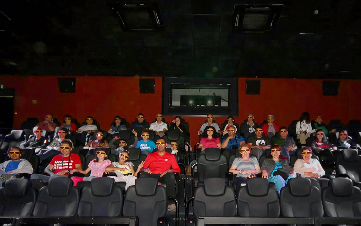 Visitors wearing 3D glasses seated in the viewing hall at Malta 5D Audio-Visual Show.