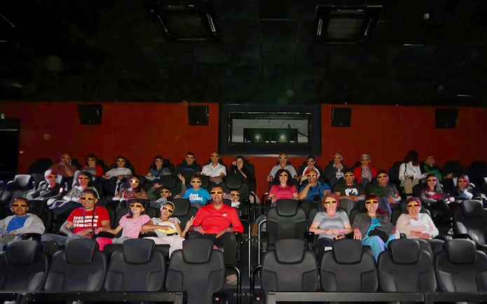 Visitors wearing 3D glasses seated in the viewing hall at Malta 5D Audio-Visual Show.