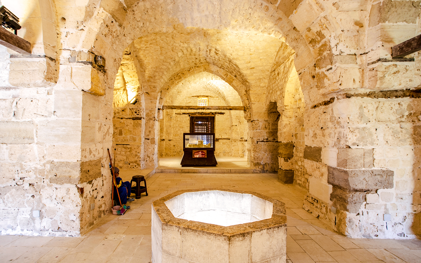 Historic stone interior with arches and a central display in Cairo.
