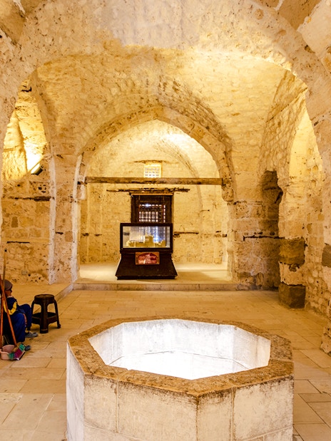 Historic stone interior with arches and a central display in Cairo.