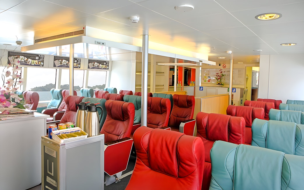 Luxurious seating area inside Singapore to Bintan Resorts ferry with refreshments.