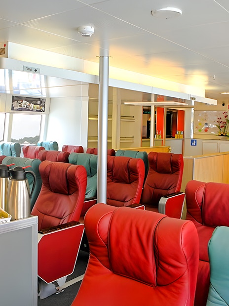 Luxurious seating area inside Singapore to Bintan Resorts ferry with refreshments.