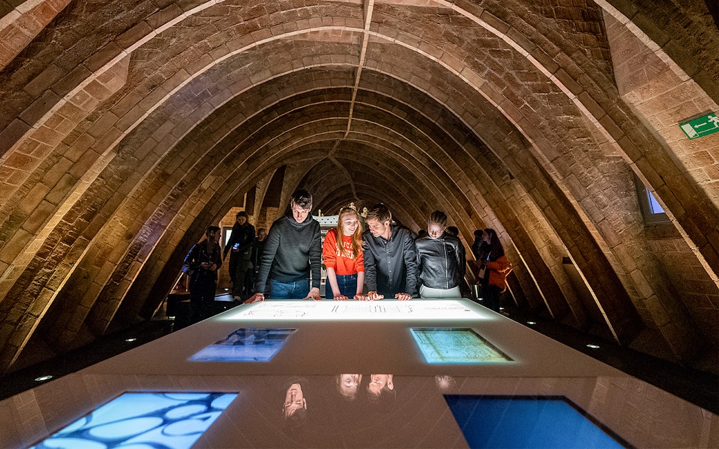 Visitors exploring exhibits at La Pedrera Sunrise Tour, Casa Milà, Barcelona.