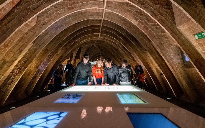 Visitors exploring exhibits at La Pedrera Sunrise Tour, Casa Milà, Barcelona.