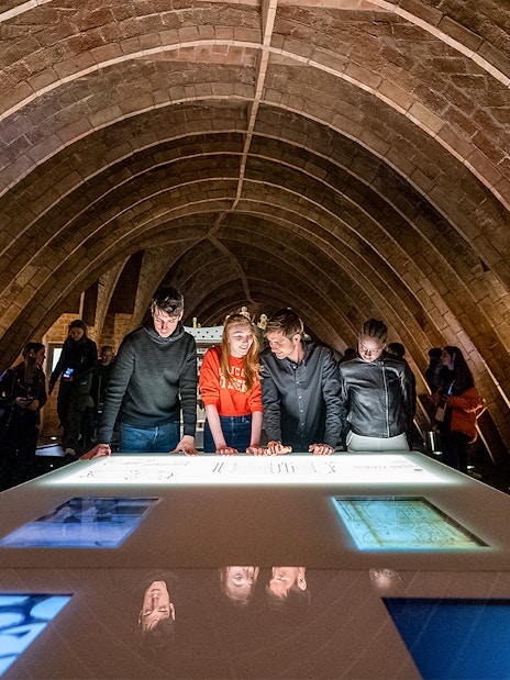 Visitors exploring exhibits at La Pedrera Sunrise Tour, Casa Milà, Barcelona.