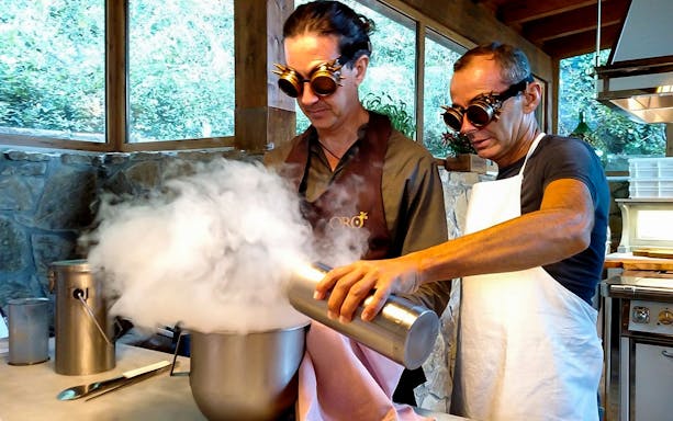 Two people using liquid nitrogen in a Tuscany farmhouse cooking class.