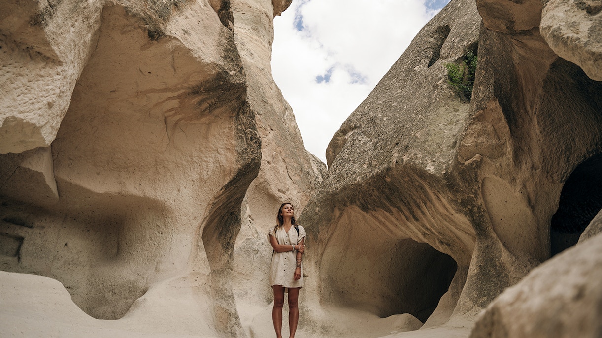 Guest exploring rock formations at Zelve Open Air Museum, Cappadocia.