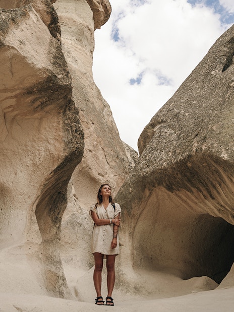 Guest exploring rock formations at Zelve Open Air Museum, Cappadocia.