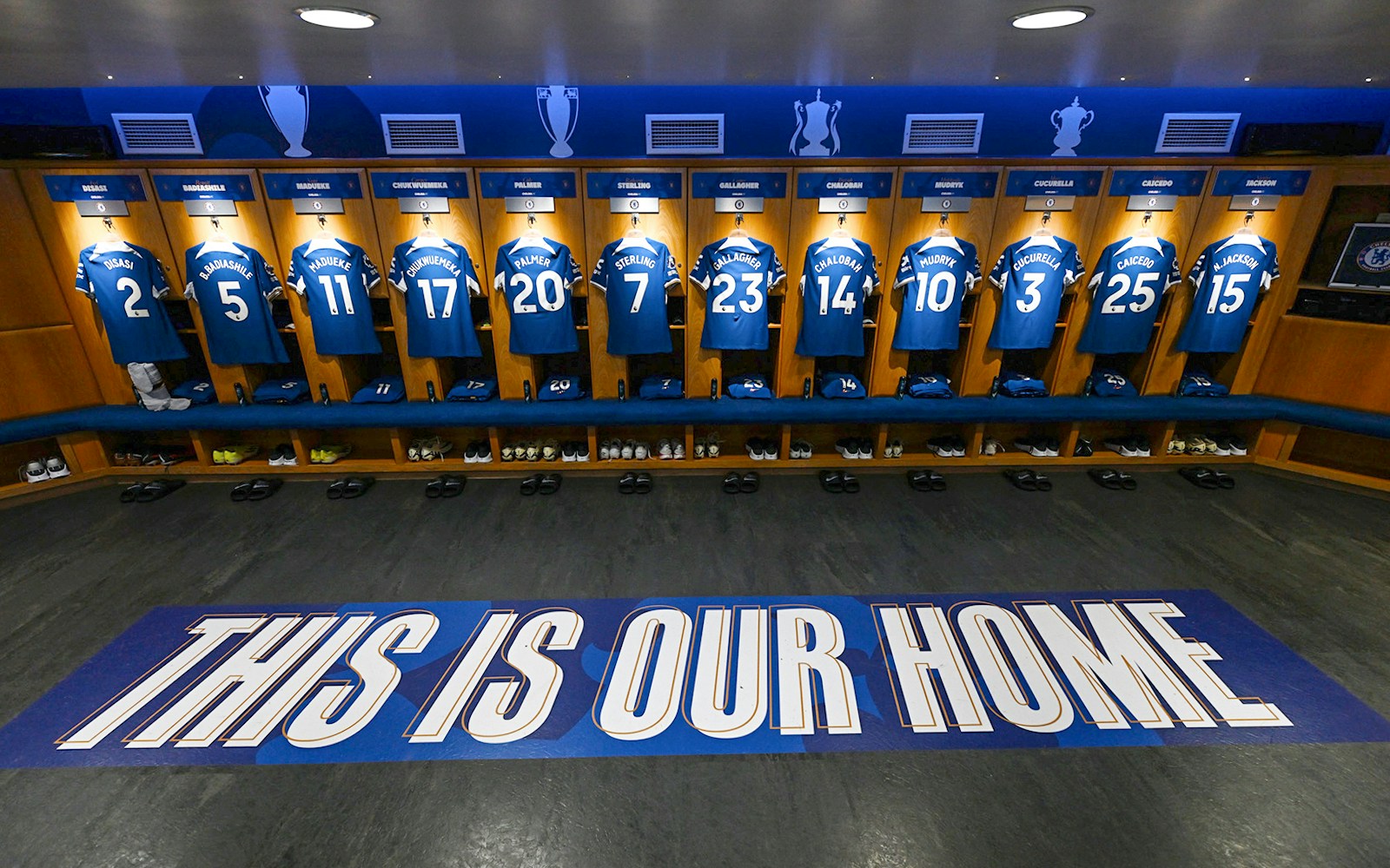 Chelsea FC locker room with player jerseys displayed during stadium tour.