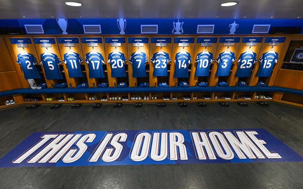 Chelsea FC locker room with player jerseys displayed during stadium tour.